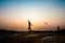 Silhouette of children flying a kite at sunset