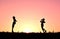 Silhouette children playing string phone