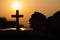 Silhouette of christian young woman praying with a cross and open the bible at sunrise, Christian Religion concept background