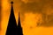 Silhouette of a church steeple, against a bright yellow, fiery-looking sky during sunset, Harlem, New York City, USA