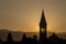 Silhouette of church and tower on orange background