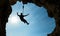 Silhouette of a climber over blue sky