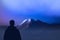 Silhouette climber stands at foot mountains watching of mountain top. expedition to Himalayas
