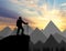 Silhouette of a climber on top looks into the distance over the mountains