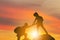 Silhouette of climbers man gived hand for pull hikers team to peak of mountain for work together, Sport and Teamwork Concept