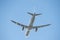 Silhouette of a climbing airliner with shiny fuselage