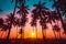 Silhouette coconut palm trees on beach at sunset.