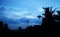 silhouette coconut tree with building construction, Beautiful cloudy sunset,view of clouds