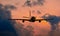 Silhouette of commercial airplane jetliner flying above dramatic clouds in beautiful sunset light. Travel concept