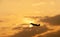 Silhouette of commercial airplane taking off at sunset