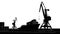 Silhouette commercial port with container ship at the pier and cargo cranes