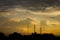 Silhouette communication antennas in evening cloudy sky