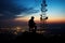 Silhouette of communication tower against twilight sky with person testing signal. Generative AI