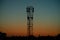 Silhouette of a communication tower mobile operator`s antenna