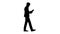 Silhouette Concentrated Businessman reading documents or report while walking.