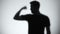 Silhouette of confident man showing biceps, bodybuilding and fitness, close-up