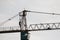 Silhouette of consruction worker on top of tower crane