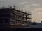 Silhouette of a construction site with scaffolding at sunset. Construction industry. Office of residential property development