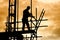 Silhouette construction worker on scaffolding building site