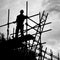 Silhouette construction worker on scaffolding building site