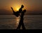 Silhouette couple in the active ballroom dance on sunset