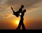 Silhouette couple in the active ballroom dance on sunset