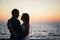 Silhouette of a couple at the beach at sunrise sky summer time, seashore summer beach at yellow blue evening horizon sea, sunset b