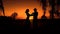 Silhouette of couple dancing in a country sunset