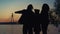 Silhouette couple daughter enjoy river sunset lear sky. Caring people together.