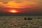 Silhouette of couple are kayaking in the sea at sunset. Kayak in the tropical sea at sunset. Romantic couple travel on summer