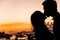 Silhouette of couple kiss on the beach at the sunrise and sunset