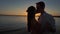 Silhouette couple kissing over sunset background