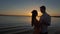 Silhouette couple kissing over sunset background