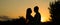 Silhouette couple kissing over sunset background, Profiles of romantic couple looking at each other on background of sunset