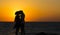 Silhouette of a couple in love on the beach at sunset.
