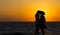 Silhouette of a couple in love on the beach at sunset.Love story.Man and a woman on the beach.