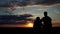 Silhouette of couple in love spinning in hug, enjoys each other, romantic sunset