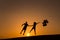 Silhouette of a couple playing with balloons at sunset