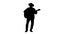 Silhouette Cowboy man with acoustic guitar singing a song.