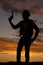 Silhouette of a cowboy with a pistol held up