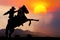 The silhouette of the cowboy and setting sunset