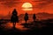 Silhouette of cowboys riding horses at sunrise