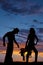 Silhouette of a cowgirl hold saddle hand on hip