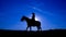 Silhouette cowgirl on horse at sunset in blue 2