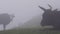 Silhouette cows grazing on alpine pasture in mist