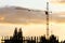 Silhouette of crane and building under construction in evening