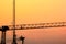 Silhouette cranes at construction side with the twilight sky