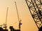 Silhouette Cranes working on Building Construction site sunset sky