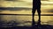 Silhouette and cropped image concept lonely boy standing at sandy beach with beautiful sunrise sunset