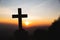 Silhouette the cross in hands, religion symbol in light and landscape over a sunrise, background, religious, faith concept
